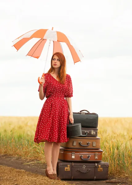 Redhead girl with suitcases at outdoor — Stock Photo, Image