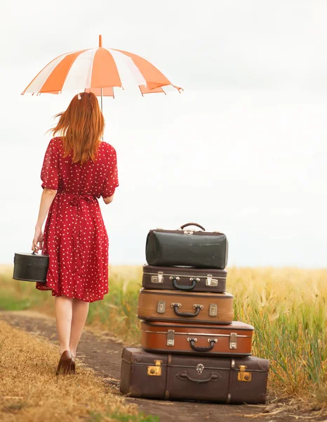 Redhead girl with suitcases at outdoor — Stock Photo, Image