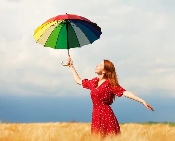 Redhead girl with umbrella at field — Stock Photo, Image