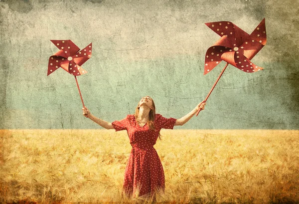 Redhead girl with toy wind turbine — Stock Photo, Image