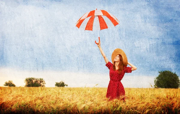 Redhead girl with umbrella at field — Stock Photo, Image