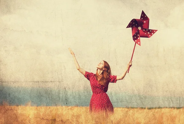 Redhead girl with toy wind turbine — Stock Photo, Image