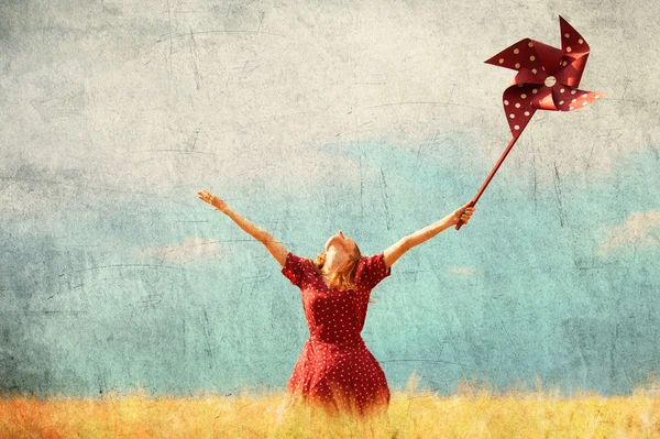 Redhead girl with toy wind turbine — Stock Photo, Image