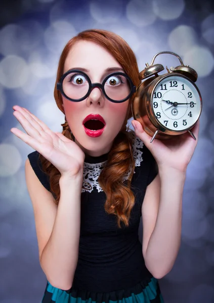 Surprised redhead girl with clock. — Stock Photo, Image