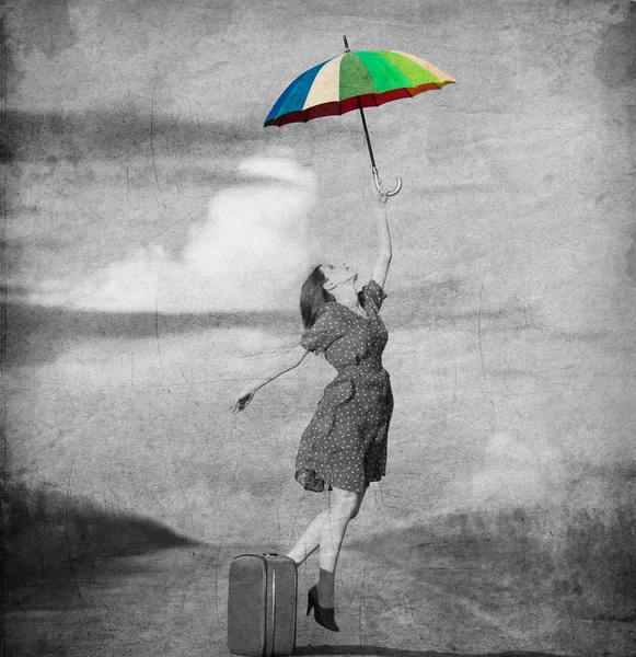 Redhead girl with umbrella and suitcase at outdoor — Stock Photo, Image