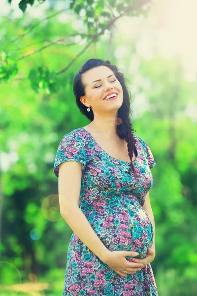 Young beautiful pregnant woman in the park Royalty Free Stock Photos