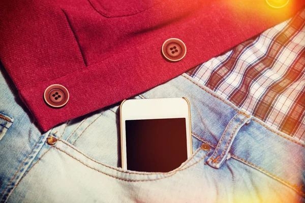 Mobile phone in jeans pocket — Stock Photo, Image