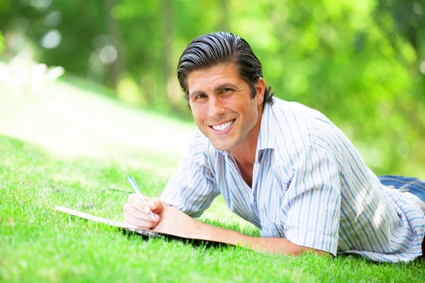 Young student with note at outdoor — Stock Photo, Image