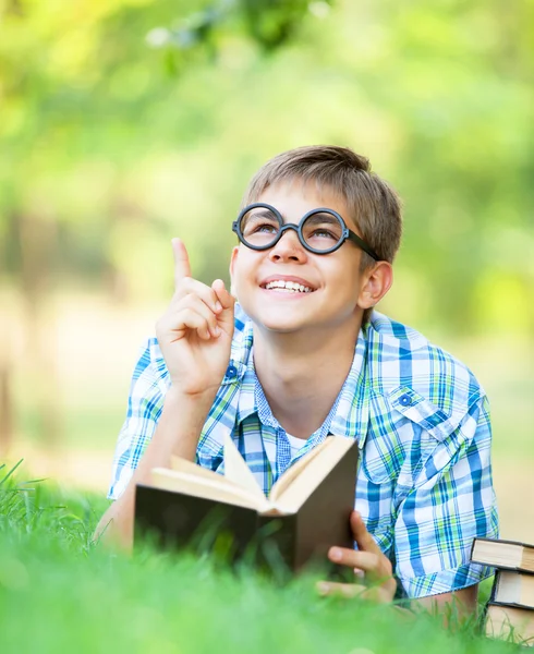 Dospívající chlapec s knihami v parku. — Stock fotografie