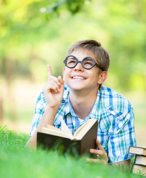 Tiener jongen met boeken in het park. — Stockfoto