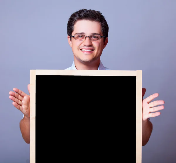 Schöner Mann mit Tafel. — Stockfoto