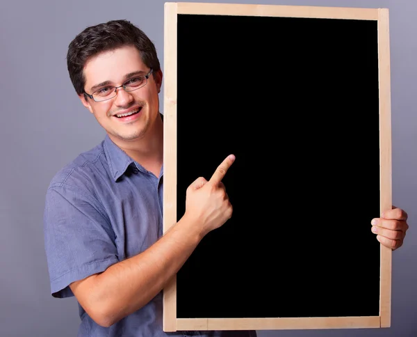 Handsome man with blackboard. — Stock Photo, Image