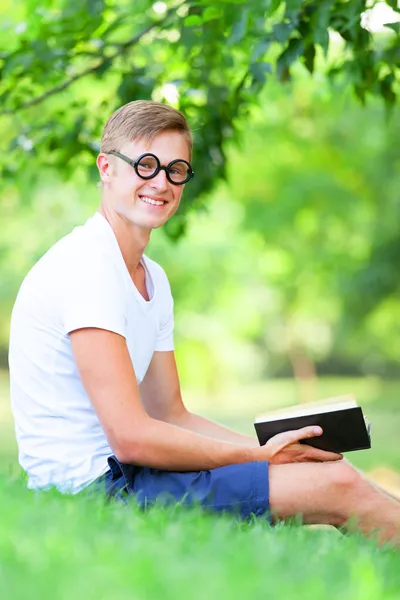 Adolescente chico con libros en el parque . — Foto de Stock