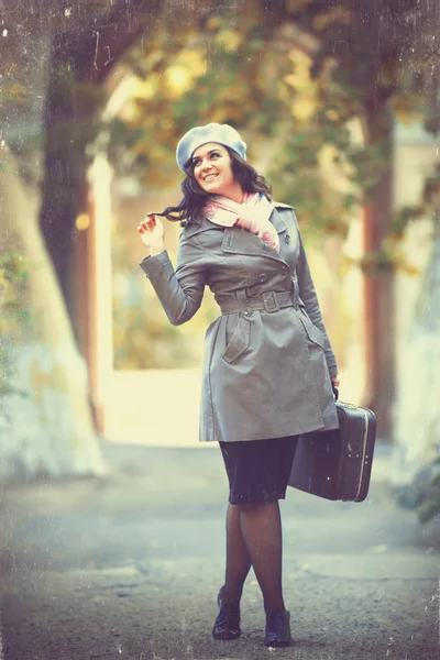 Girl with suitcase at autumn outdoor — Stock Photo, Image