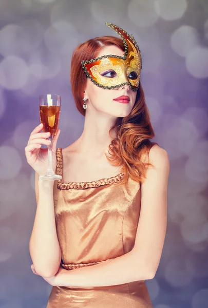 Rödhåriga kvinnor i mask med champagne — Stockfoto