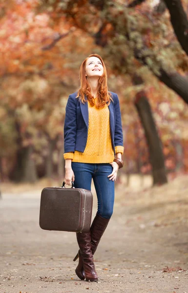 Menina com mala no outono ao ar livre — Fotografia de Stock