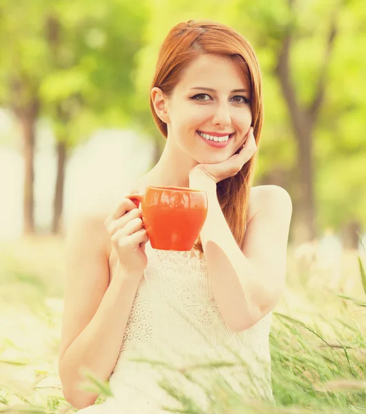 Fille rousse avec tasse orange à l'extérieur — Photo