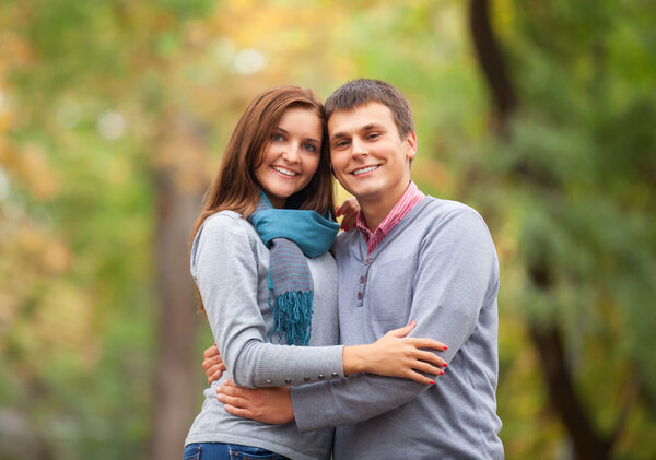 Teen couple at autumn park