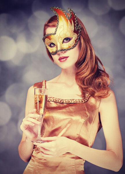 Redhead women in mask with champagne