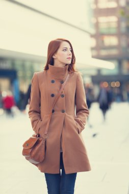 Redhead women walking on the street