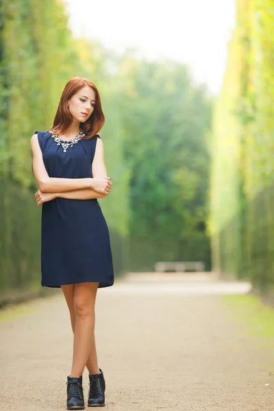 Beautiful redhead women in versailles gardens — Stock Photo, Image