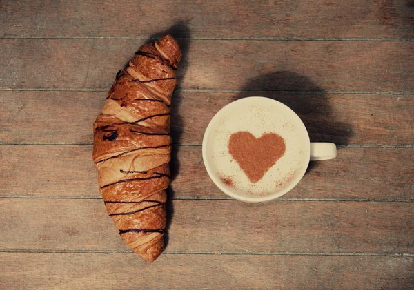 Cup of coffee with french croissant — Stock Photo, Image
