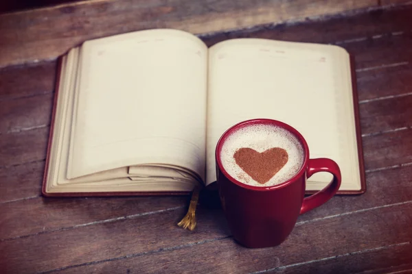 Cup of coffee with notebook — Stock Photo, Image