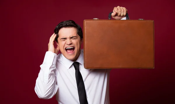 Man with case at red background — Stock Photo, Image