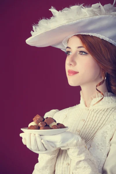 Beautiful redhead women with candy. — Stock Photo, Image