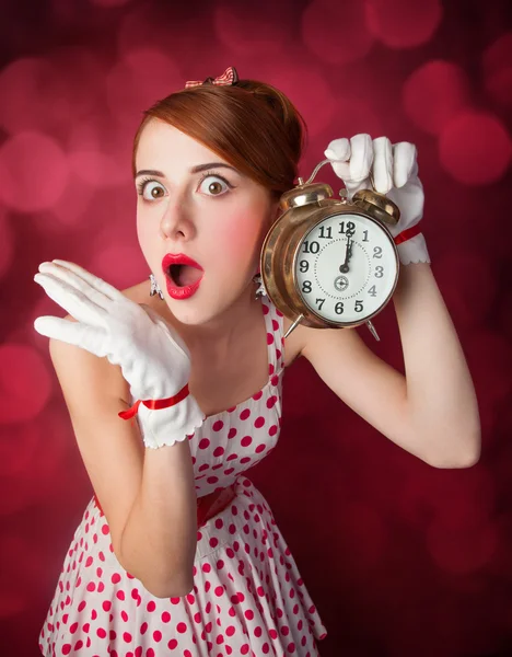 Beautiful redhead women with clock. — Stock Photo, Image