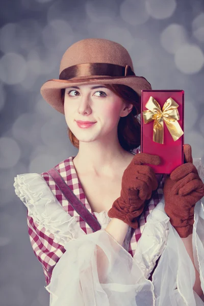 Beautiful redhead women with gift. — Stock Photo, Image