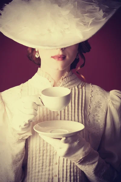 Beautiful redhead women with cup of tea — Stock Photo, Image