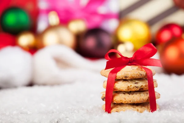 Cookies with christmas gifts on wooden table — Stock Photo, Image