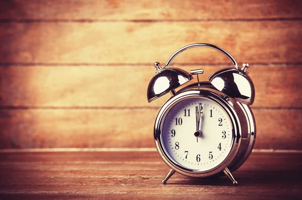 Retro alarm clock on a table — Stock Photo, Image