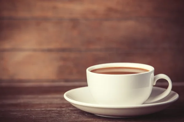 Cup of coffee on wooden table. — Stock Photo, Image