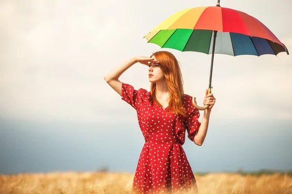 Redhead girl with umbrella at field — Stock Photo, Image