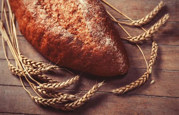 Delicious bread on a wood table — Stock Photo, Image