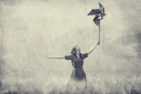 Redhead girl with toy wind turbine Stock Image