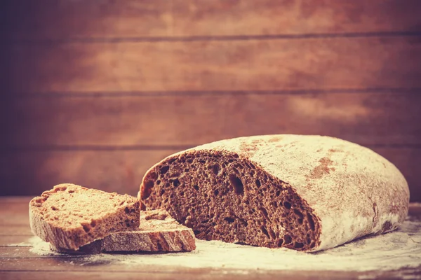 Delicious bread on a wood table — Stock Photo, Image