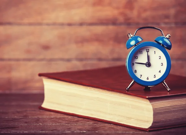 Alarm clock and book. — Stock Photo, Image