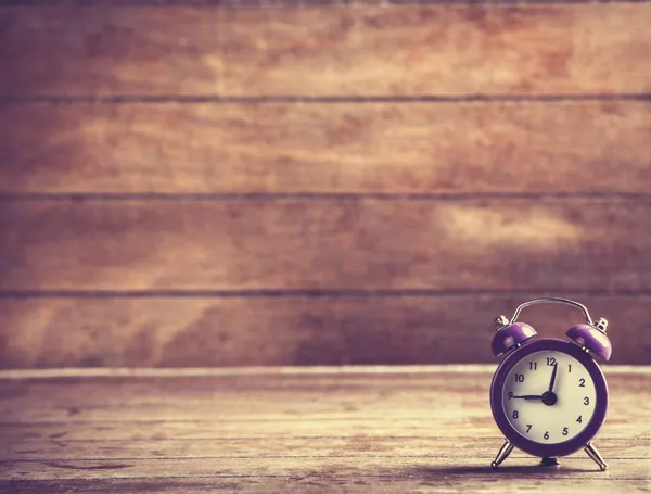 Retro alarm clock on a table — Stock Photo, Image