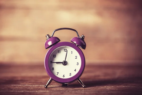 Retro alarm clock on a table — Stock Photo, Image