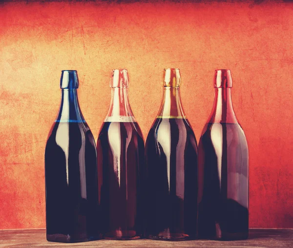 Four different bottles with young wine. — Stock Photo, Image