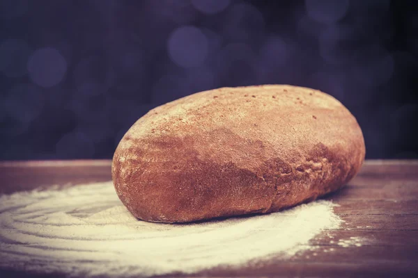 Delicious bread on a wood table — Stock Photo, Image