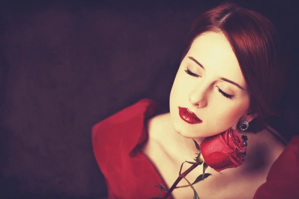 Beautiful redhead women with rose. Stock Photo