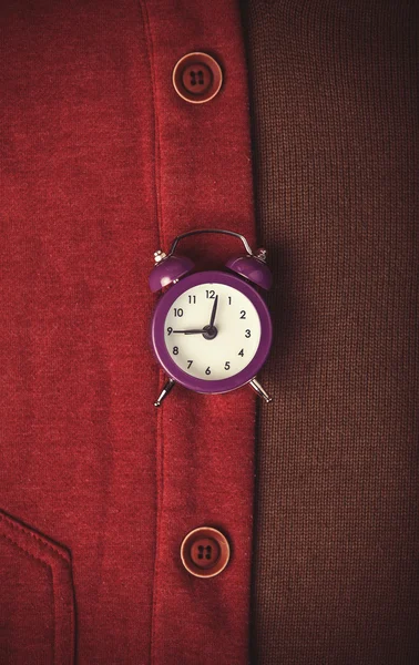 Retro alarm clock and part of clothes. — Stock Photo, Image