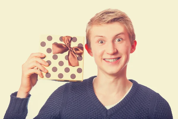 Nerd teen guy with gift. — Stock Photo, Image