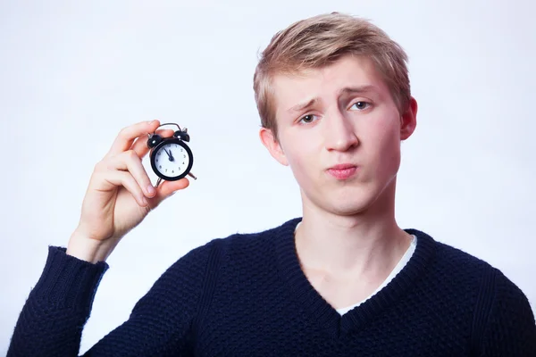 Guy with little alarm clock. — Stock Photo, Image