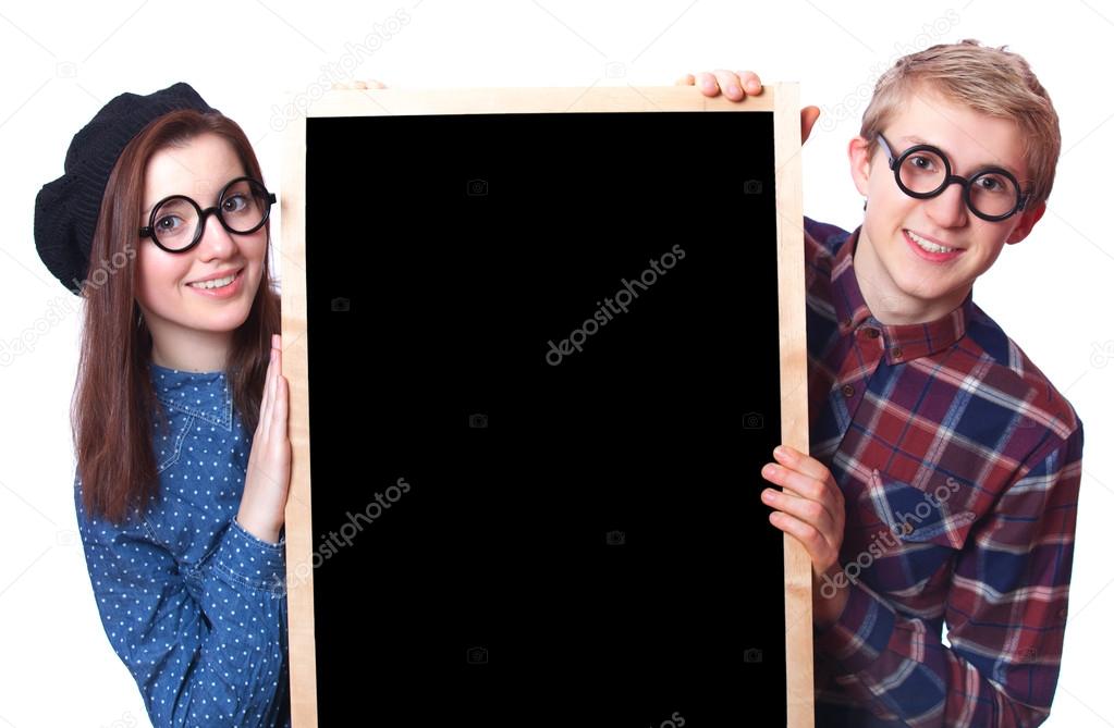 Nerd teen couple with blackboard.