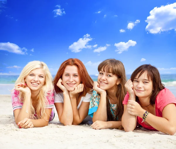 Girlfriends lying down at the beach. — Stock Photo, Image